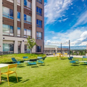Access to resident-only features a group of yellow tables and chairs outside