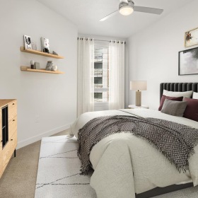 Generous bedroom offerings to fit every family a bedroom with a bed and a shelf with pictures on it