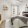 a bedroom with a bed and a shelf with pictures on it