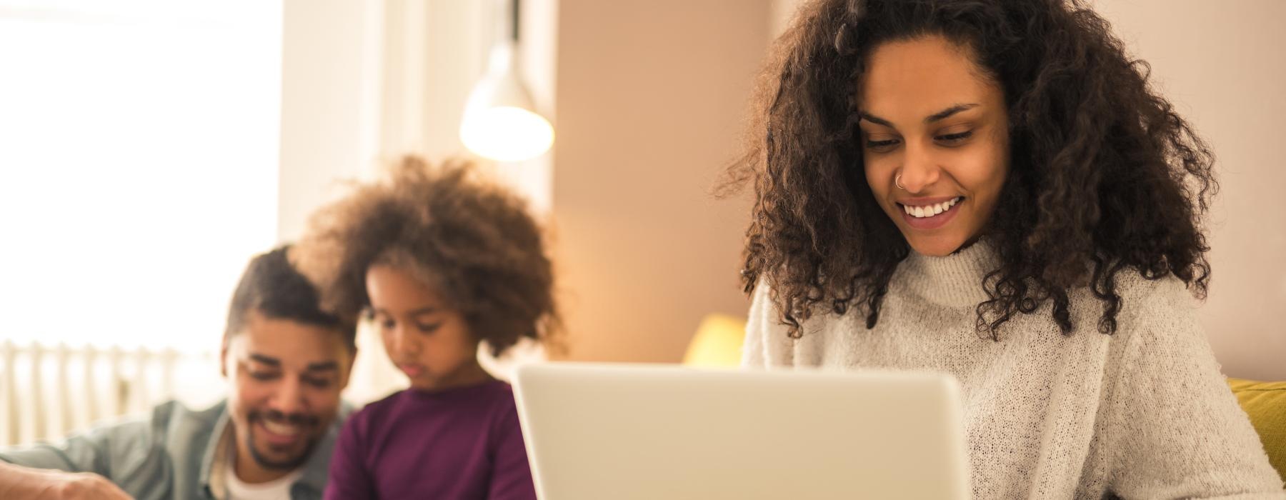 a person working on a laptop and a child coloring